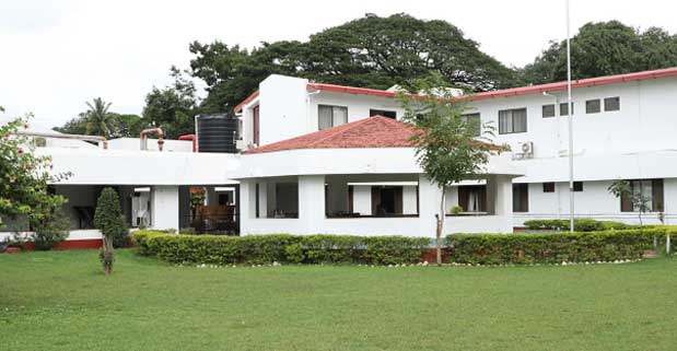 Campus building and green lawn showcasing campus life and surrounding greenery
