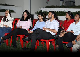 Students gathered together laughing and enjoying at KIM harihar campus at night