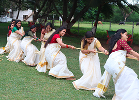 Students playing tug of war at KIM campus during an event