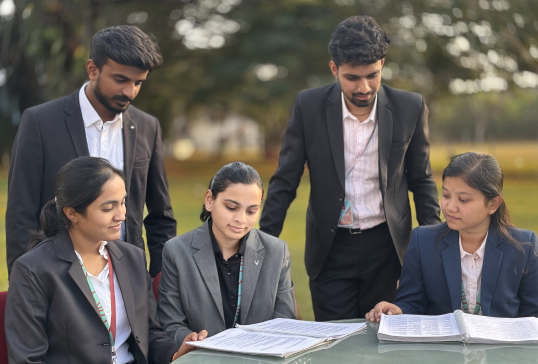 Management students and KIM Harihar Campus dressed professionally, discussing academics notes