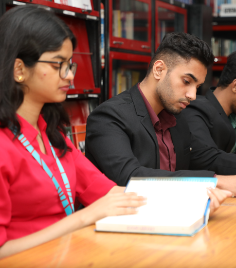 Mangement students at KIM Harihar Campus library reviewing and reading books
