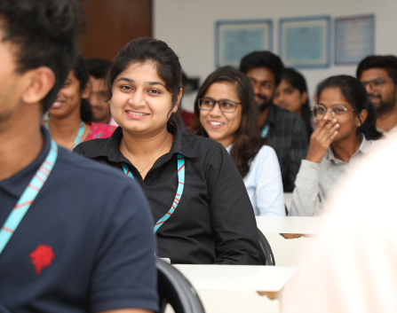 Students smiling and engaged during a classroom session at KIM Harihar
