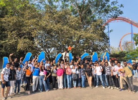 Students posing for a group photo during an outdoor campus trip, student enjoying KIM Pune campus life