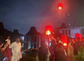 Students releasing red sky lanterns during an evening celebration, student enjoying KIM Pune campus life