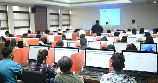 Student attending and quietly listing in a class at KIM Pune
