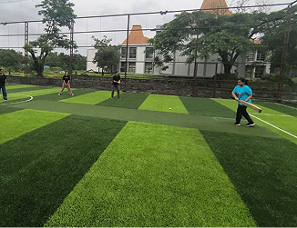 KIM management students enjoying thier time at KIM campus playing cricket in the campus playground