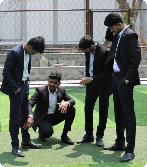 Students in formal attire discussing together on the campus sports turf