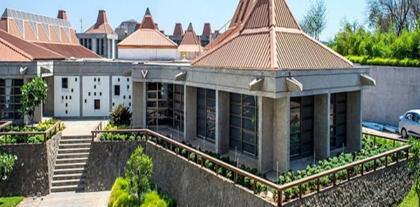 Modern campus building with tiled roof and landscaped surroundings