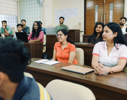 Mangement student at KIM Pune campus silently listening to speaker