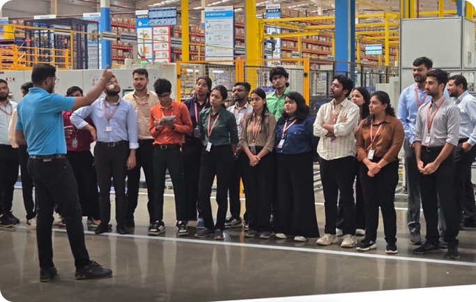 Industry visit with students listening to a professional briefing inside a manufacturing facility