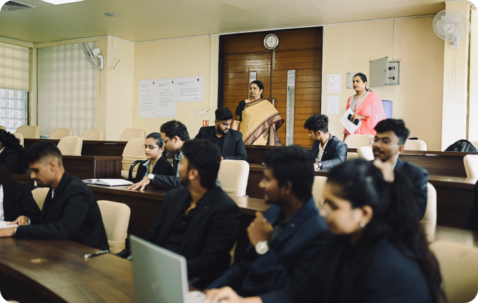 Faculty member observing students during a classroom session