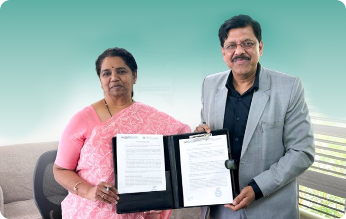 Two dignitaries holding signed documents during an official NISM academic collaboration signing ceremony